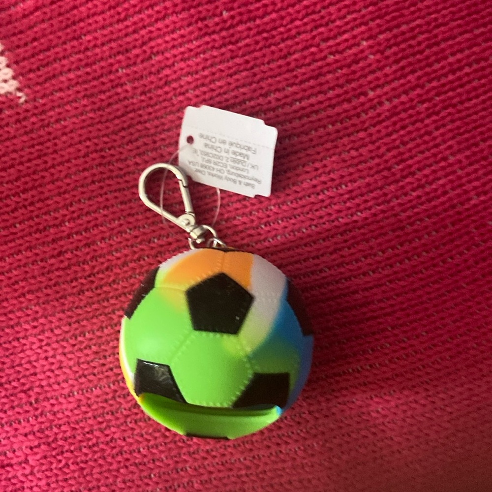 Soccer ball hand sanitizer holder
